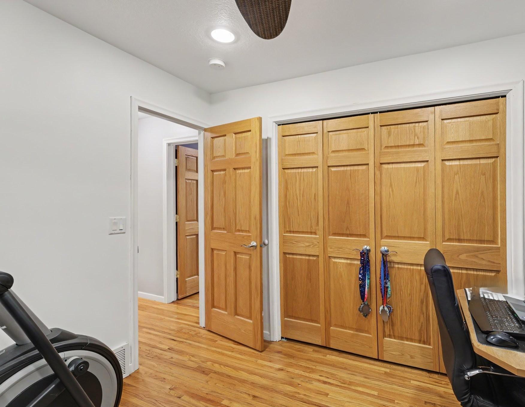 The second bedroom on the main level includes hardwood floors, a large closet, recessed lights and a ceiling fan. It's currently being used as an office and workout room.