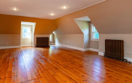 The huge third floor family room features gleaming hardwood floors.