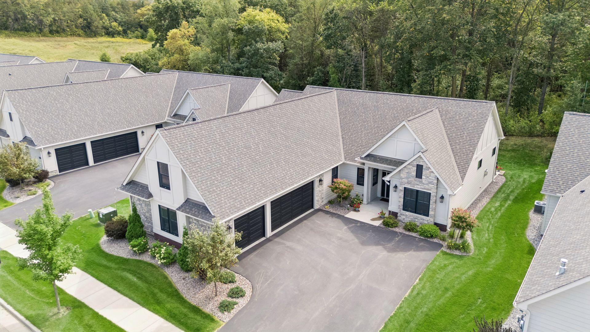 Thoughtful exterior selections shine with beautiful siding, stone accents, professional landscaping, and a spacious driveway.