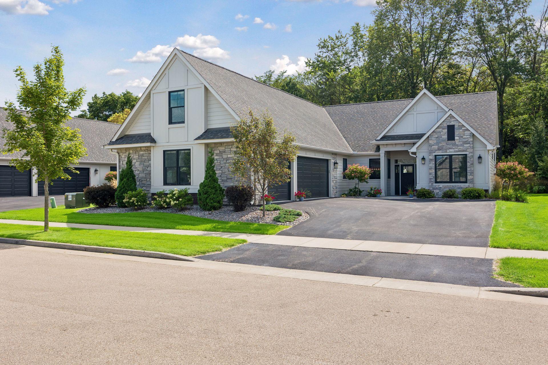Beautiful curb appeal from the street, featuring a spacious three-car garage with gorgeous windows and an inviting exterior.