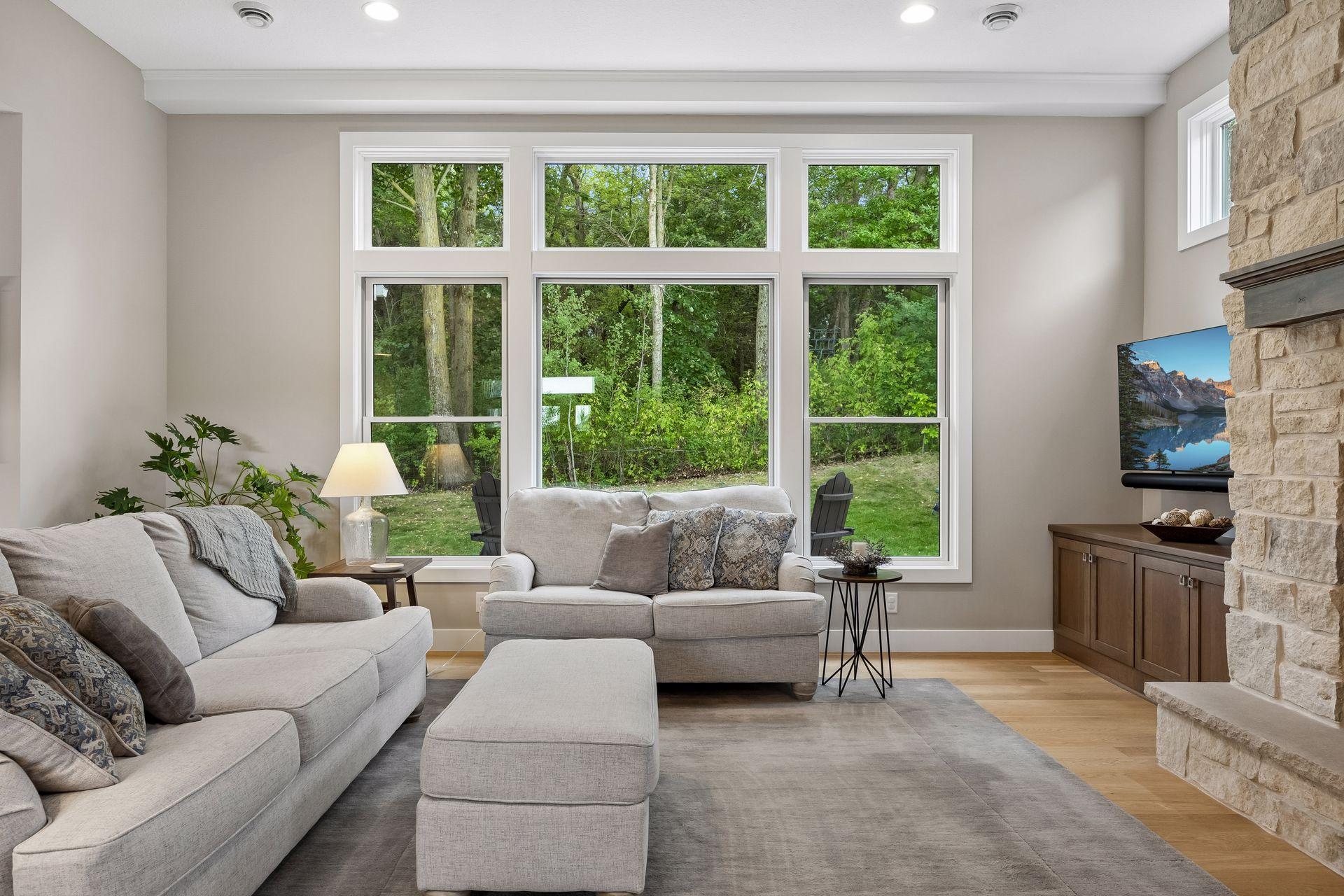 Custom windows frame the peaceful backyard setting and bring the outdoors into the main living spaces.