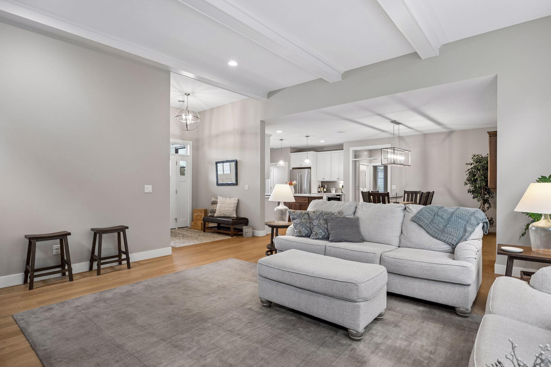 A wonderful view of the open-concept floor plan, connecting the foyer, great room, dining area, and kitchen beneath impressive 12' ceilings.