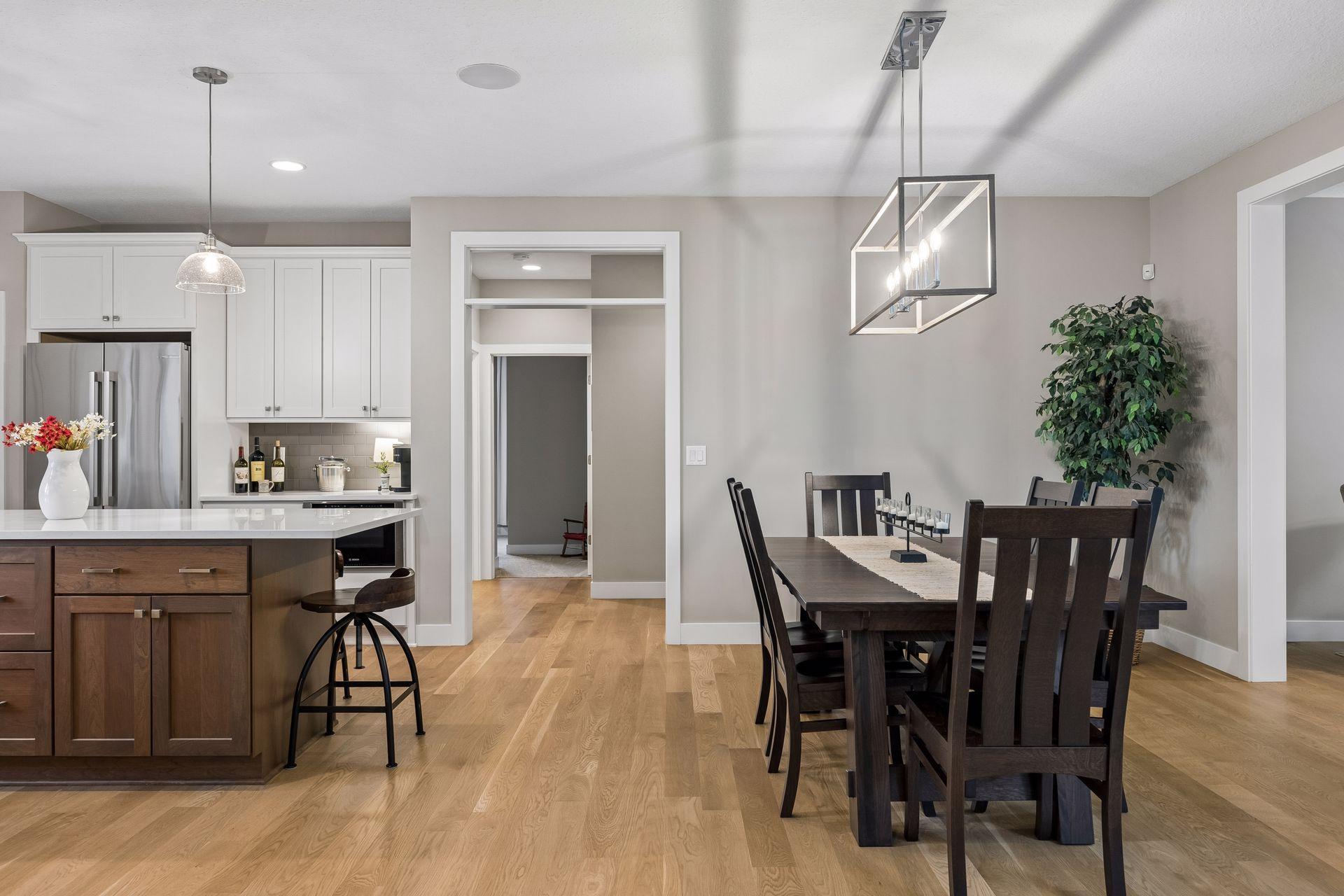 The dining and kitchen spaces sit at the heart of the home, with easy access to the main-level bedrooms and bathrooms.