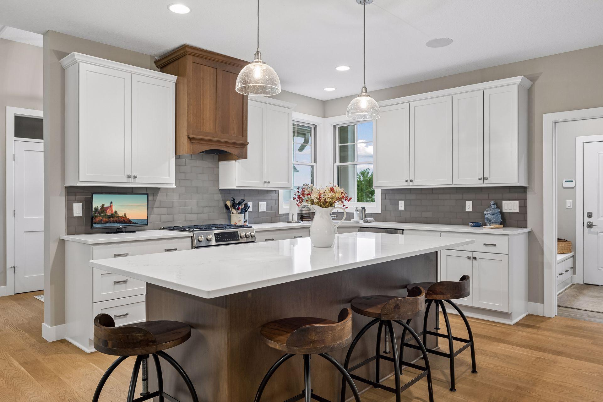 The oversized kitchen island creates another natural gathering spot with plenty of space for casual meals, conversation, and entertaining.