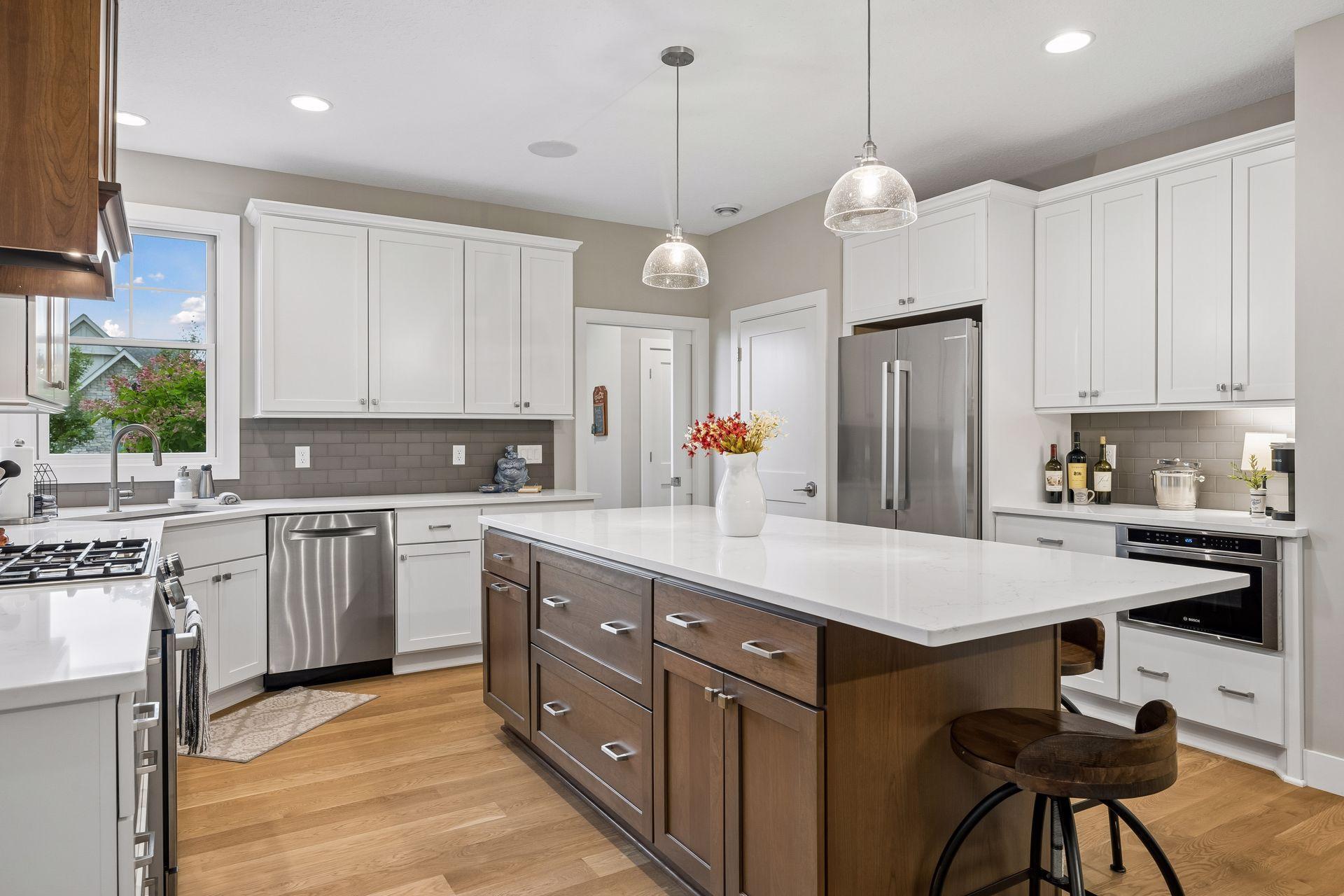 Another look at this beautifully designed kitchen featuring Vicostone quartz countertops, Bosch appliances, and a walk-in pantry.