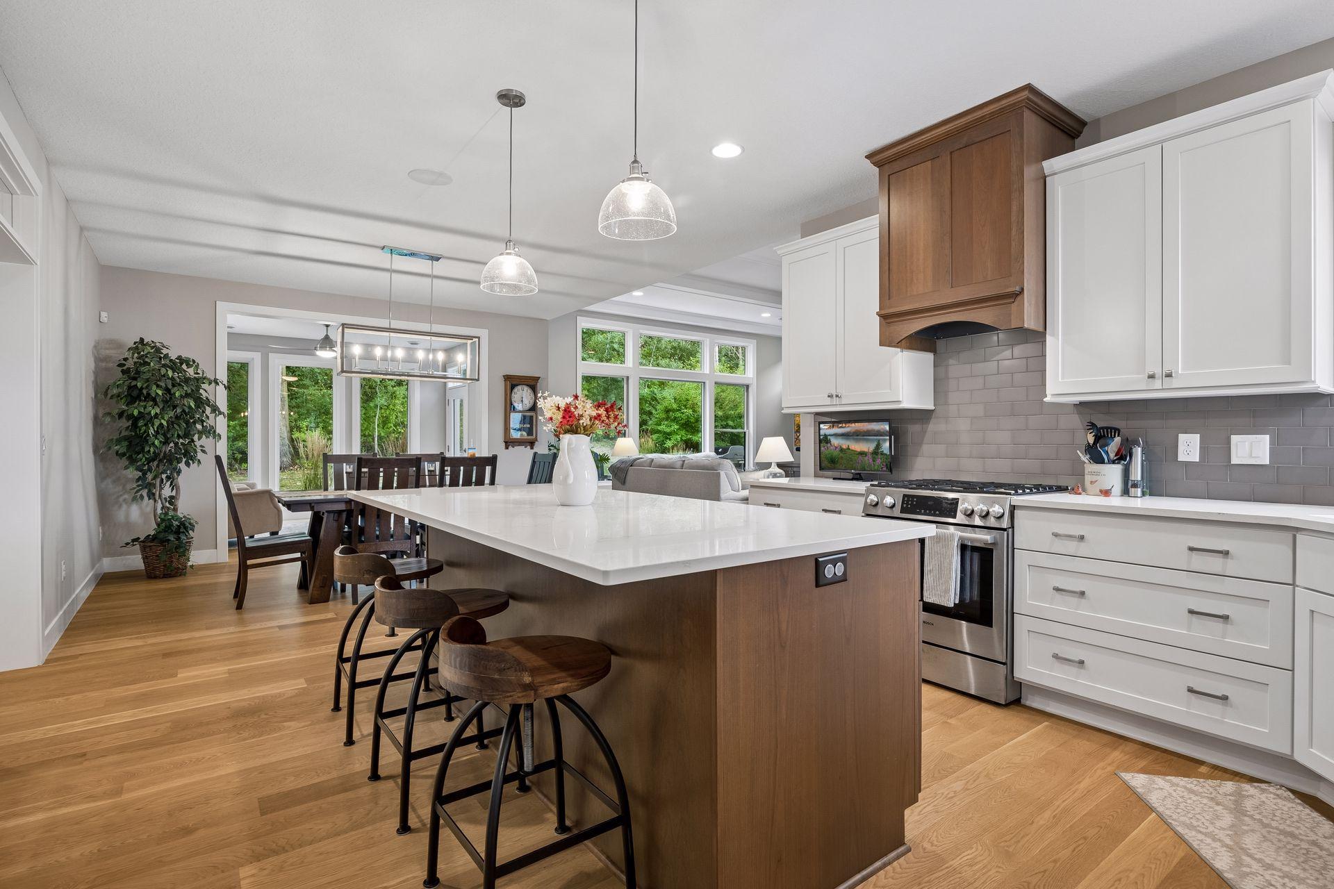 Gorgeous backsplash tile, a statement vent hood, and warm wood accents give the kitchen a beautifully finished, custom feel.