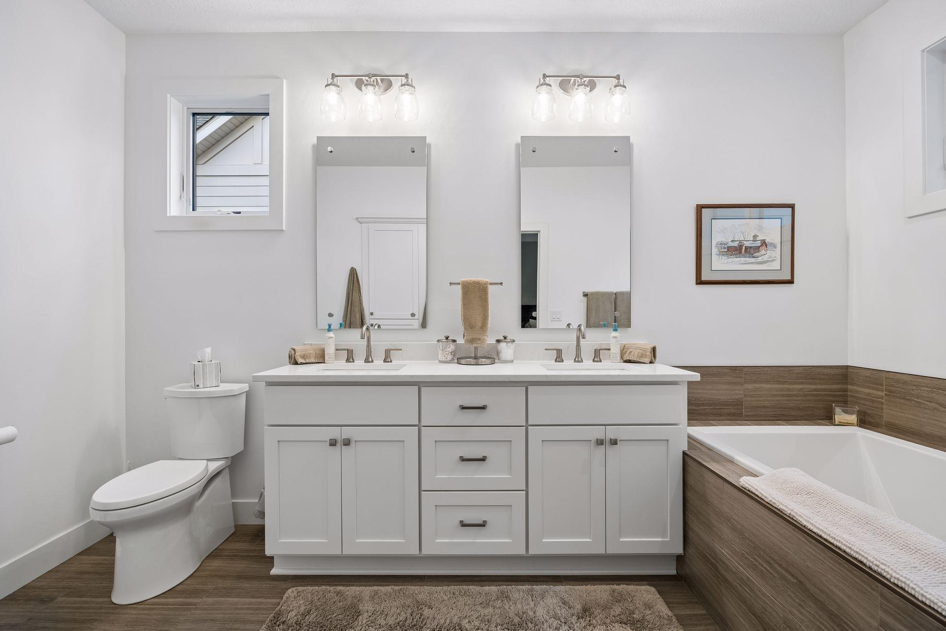The ensuite features a double vanity, separate soaking tub, and walk-in tile shower with plenty of room to start and end your day.