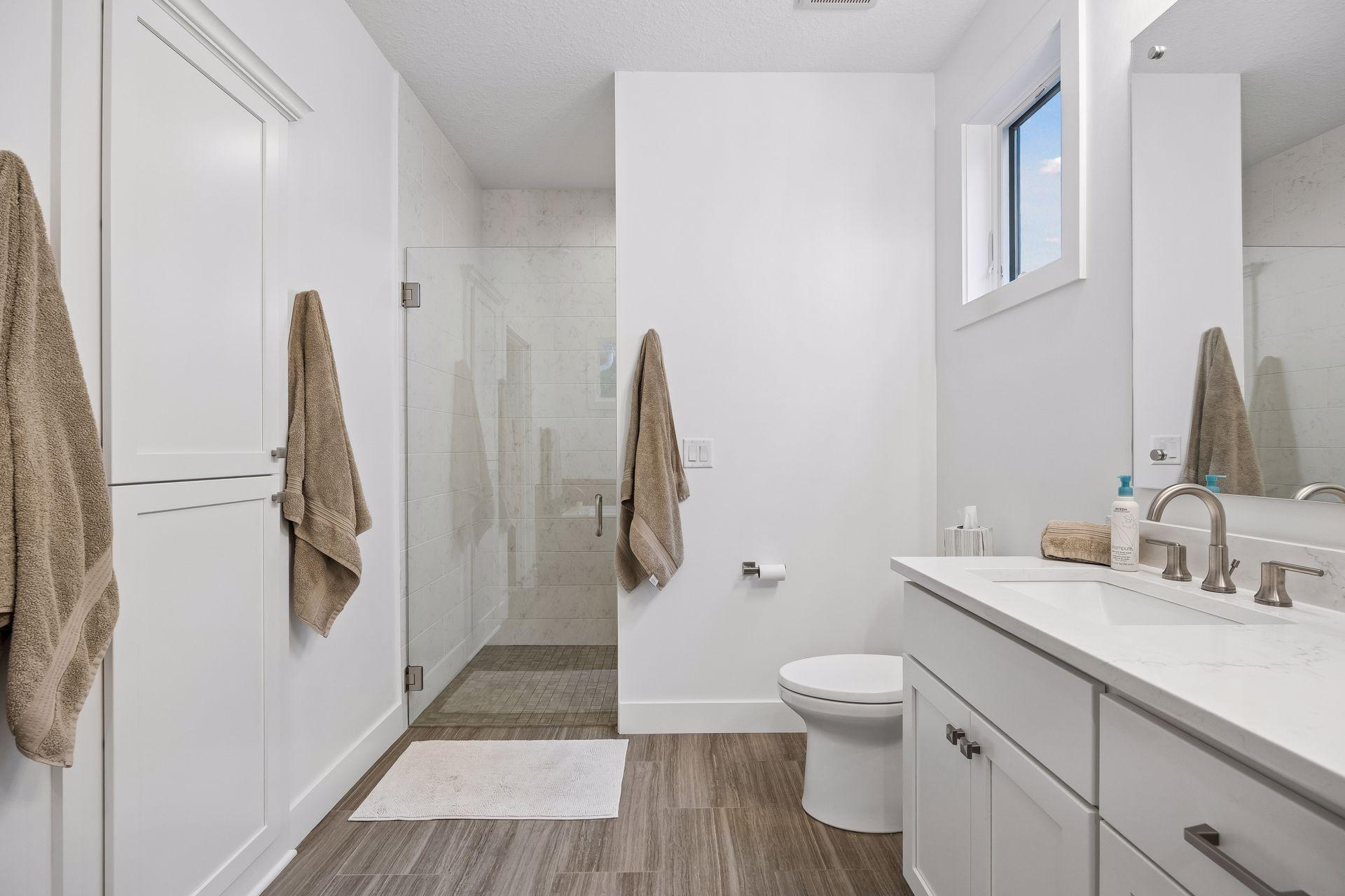 Beautiful tilework finishes the walk-in shower—and don't forget, heated floors extend throughout the entire main level!