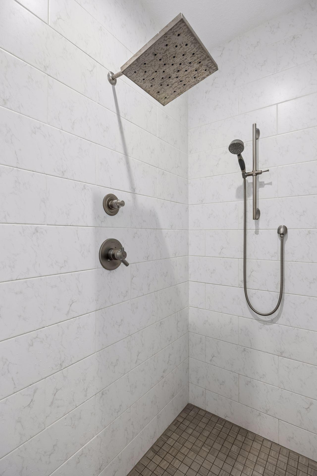 A closer look at the gorgeous tilework and thoughtful finishes inside the primary shower.