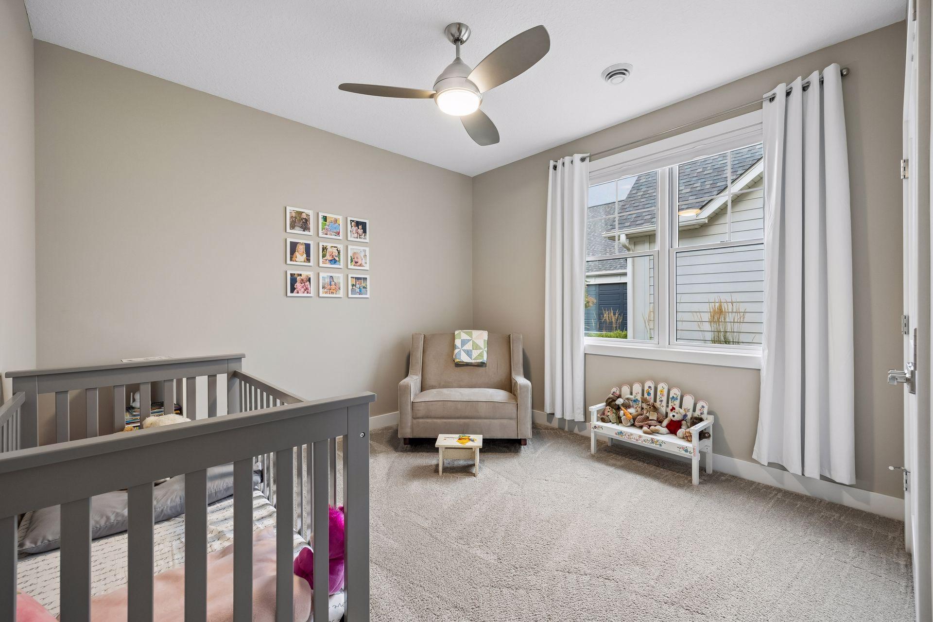 Another main-level bedroom is tucked away just off the kitchen and dining area, offering privacy from the primary suite.