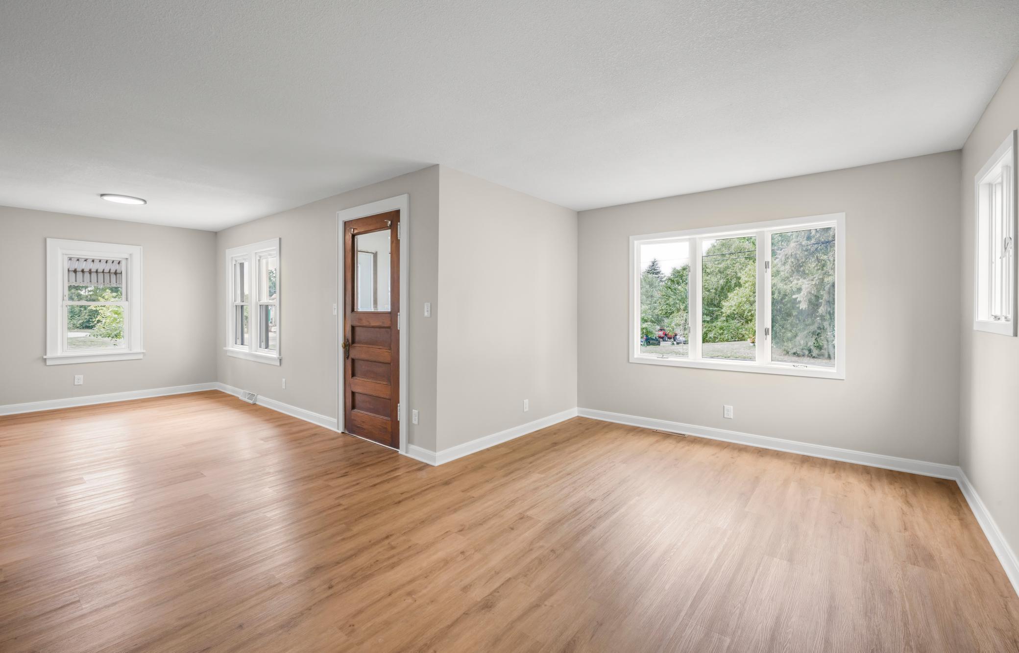 Large L-shaped living room - the main flor boasts both a living room and family room in addition to completely remodeled kitchen and full bathroom as well as a main level bedroom.