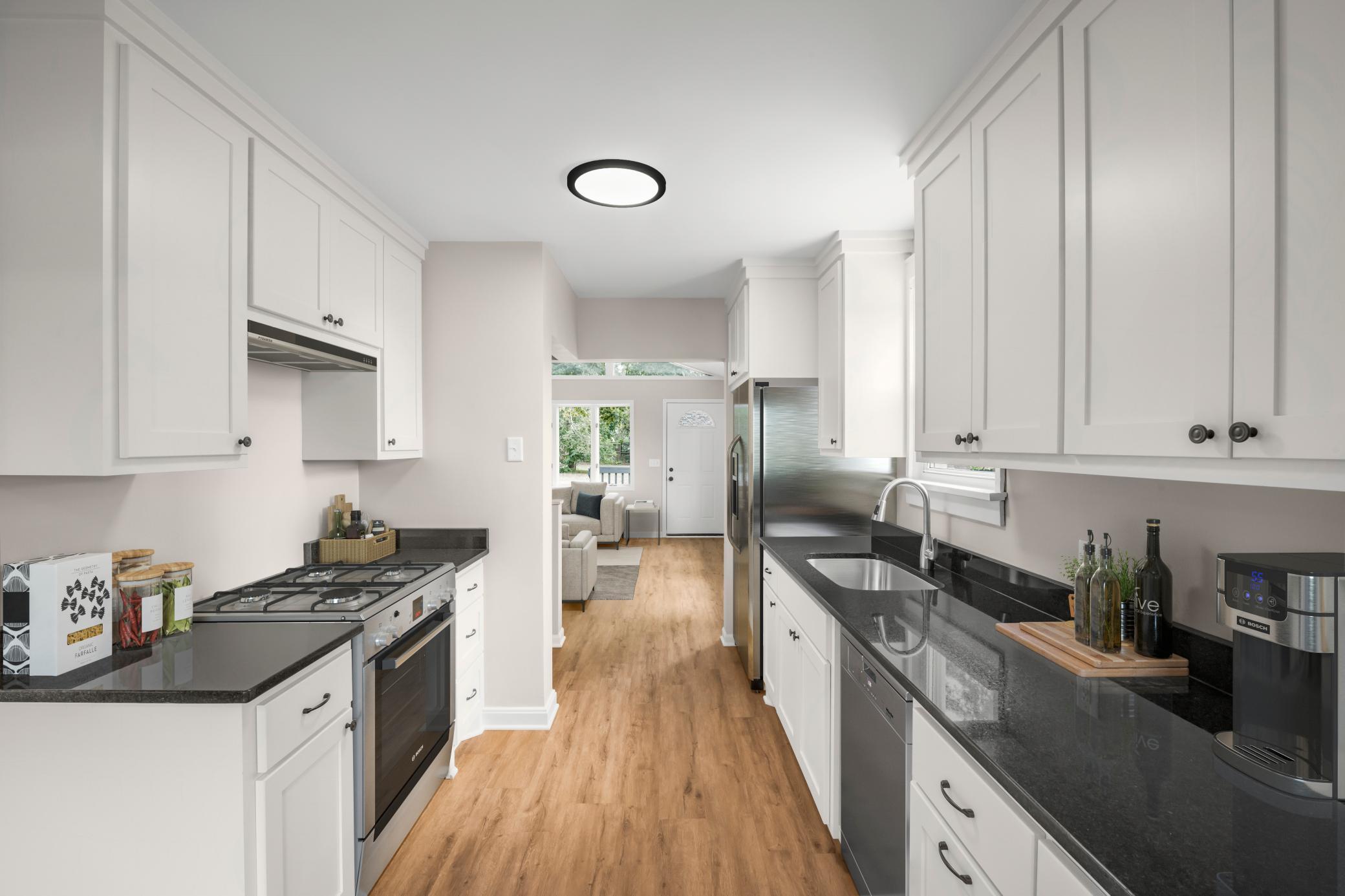 New Kitchen! Photo virtually staged. Home includes stainless steel kitchen appliances which will be installed by closing - however those in the photo are virtual