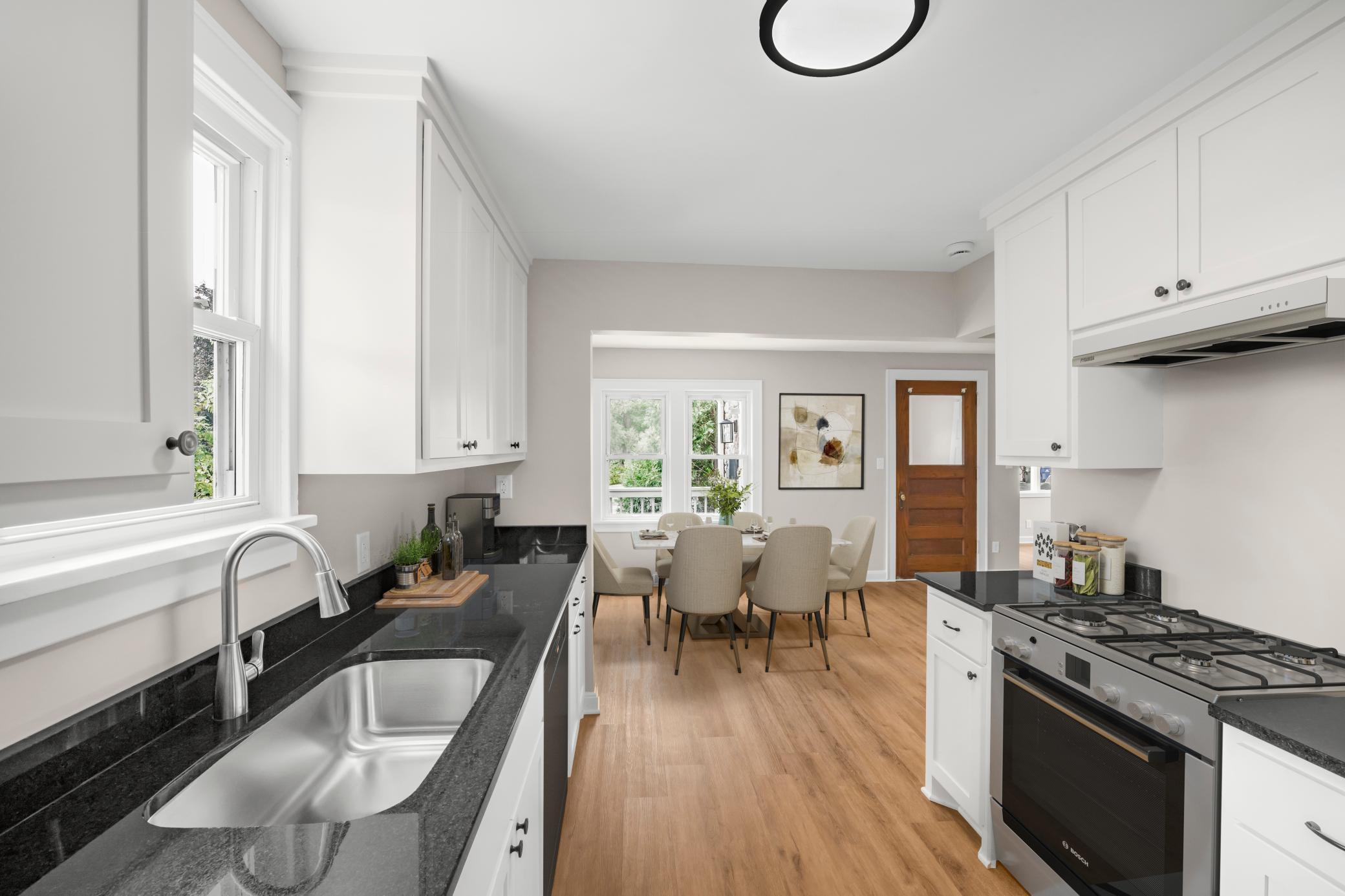 Another view of the New Kitchen! Photo virtually staged. Home includes stainless steel kitchen appliances (refrigerator, range, dishwasher and microwave over range) which will be installed by closing - however those in the photo are virtual