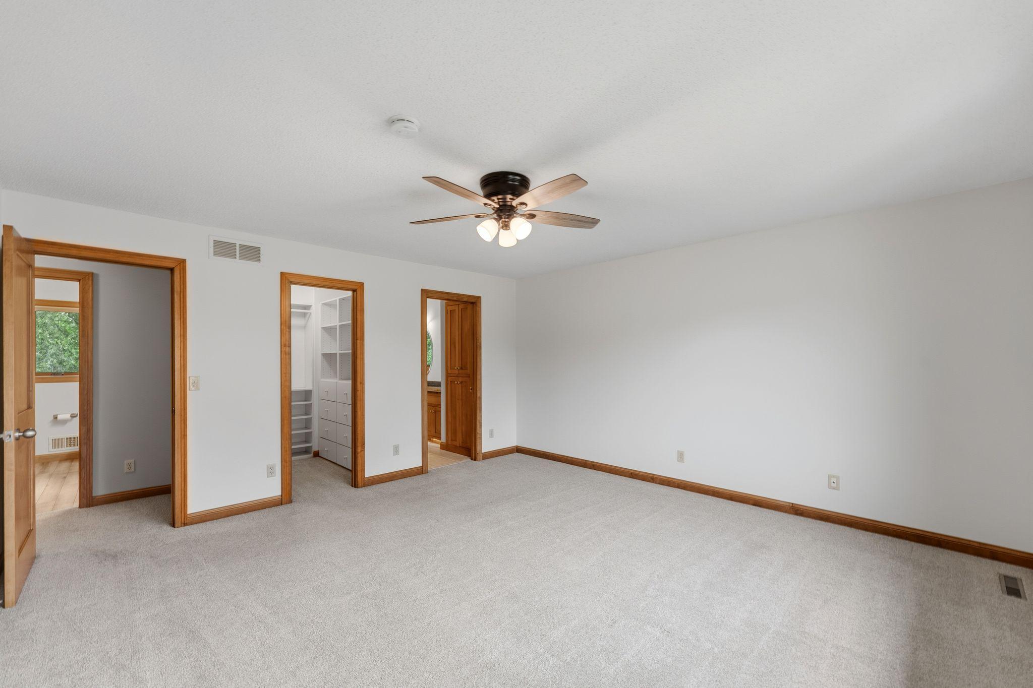Primary bedroom on upper level: Freshly painted, new carpet, PLUS a walk-in closet w/ professional organization system, full, private bathroom w/ dual-sinks, cabinetry, jetted-whirlpool tub, radiant in-floor heat, separate shower - AND a ceiling fan!
