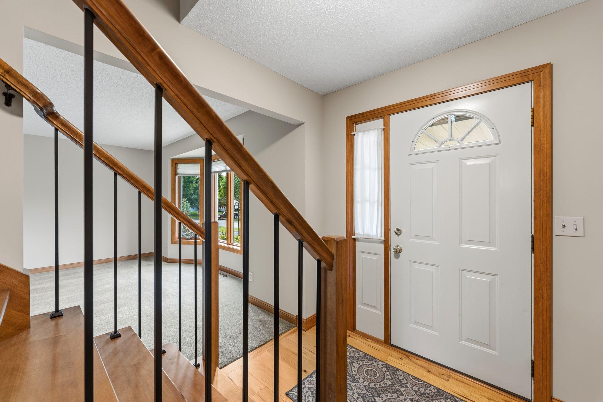 The front foyer -- welcomes your guests with new flooring, fresh paint, new lighting and a new GORGEOUS staircase with updated balusters, railing and banisters!