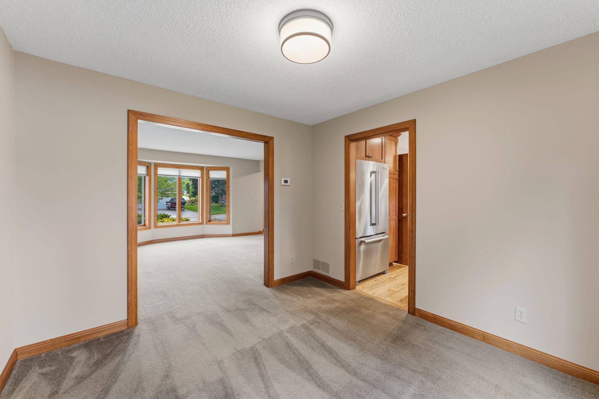 The formal dining room sits just off of the kitchen and living room. Freshly painted and new lighting!