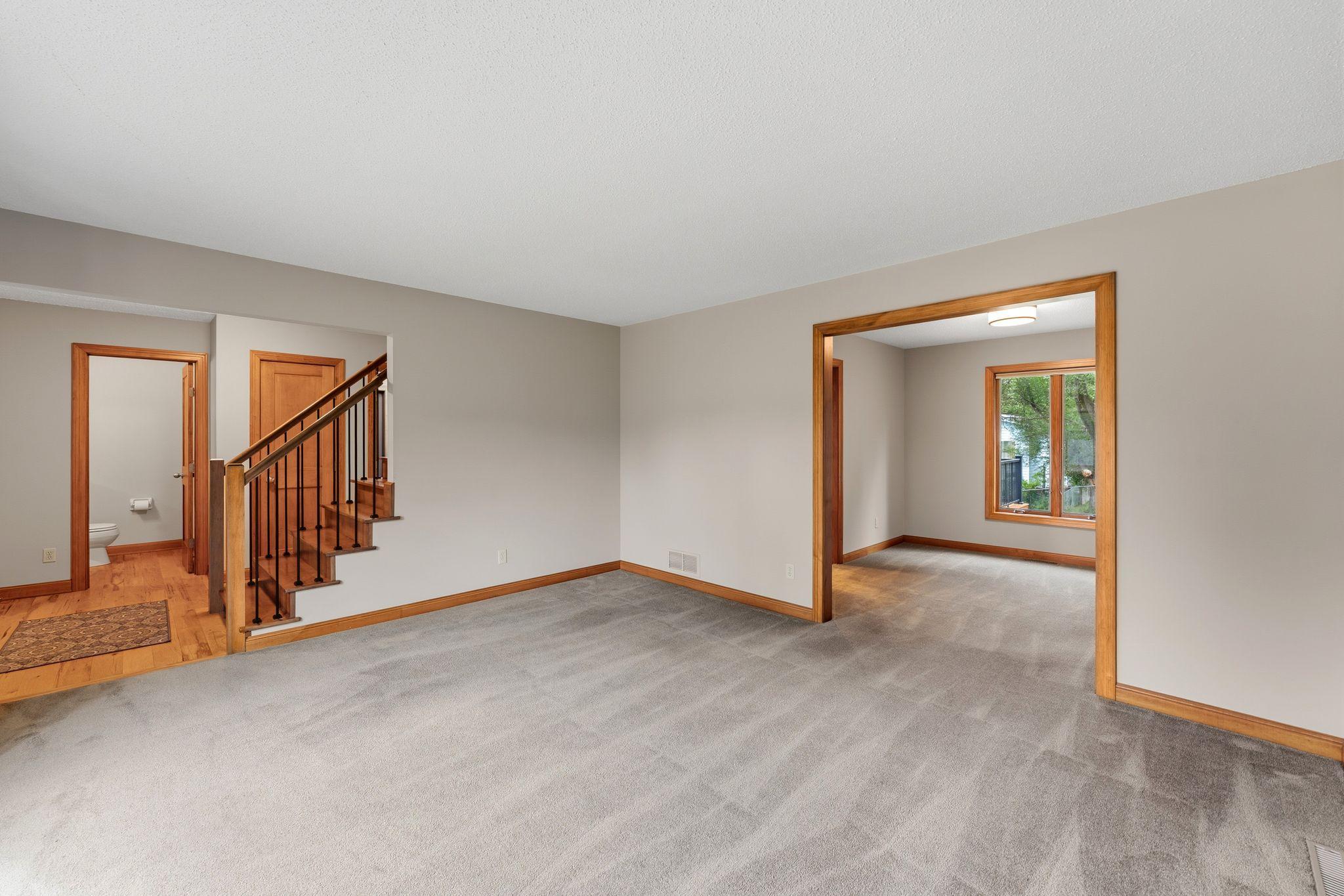 Main floor living room and looking at the beautifully updated foyer and staircase -- the formal dining room is connected to the living space.