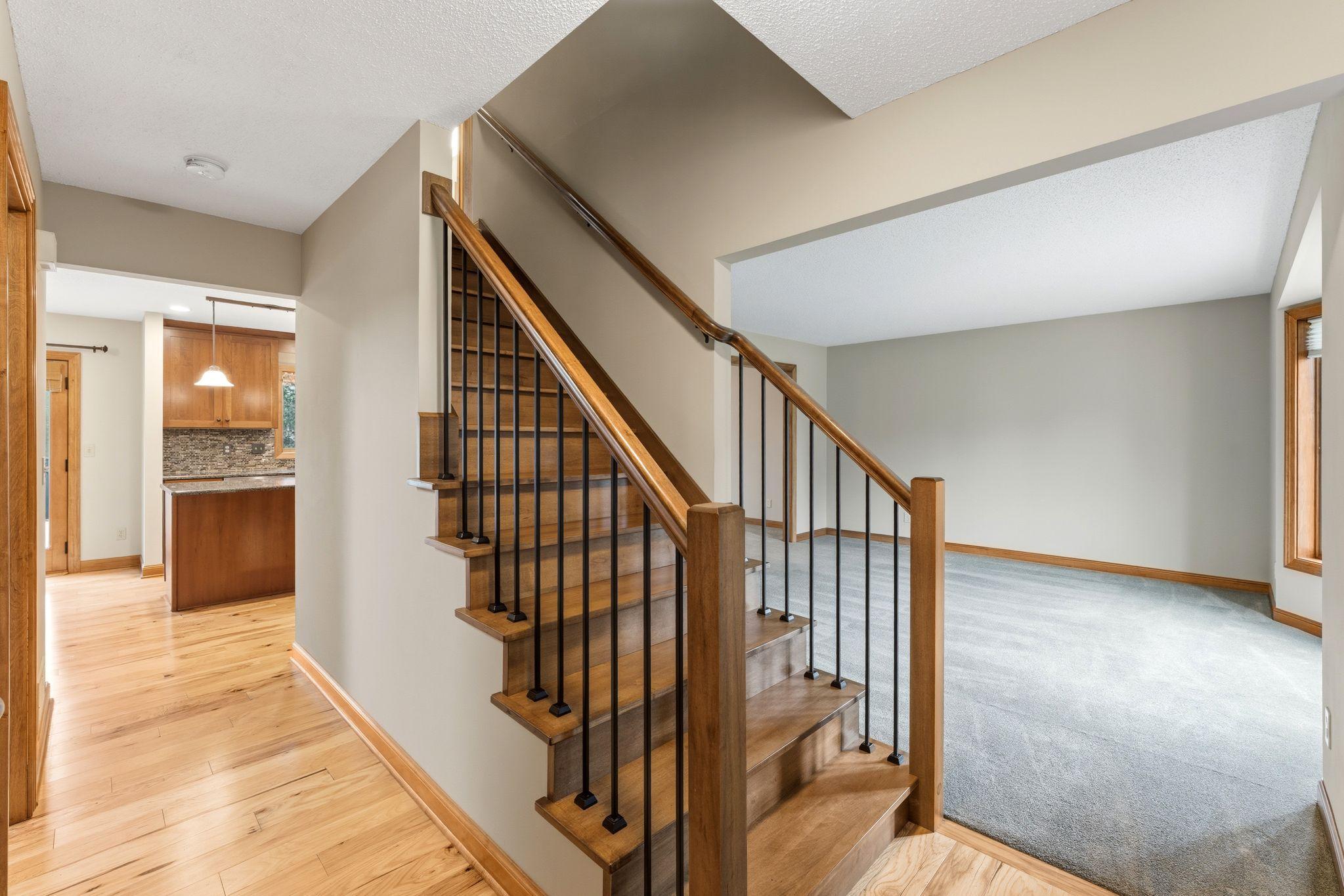 Step inside and you're immediately drawn to the gorgeous, updated and sleek design of the stairway! NEW railings, HW (maple) staircase and just so pretty!!