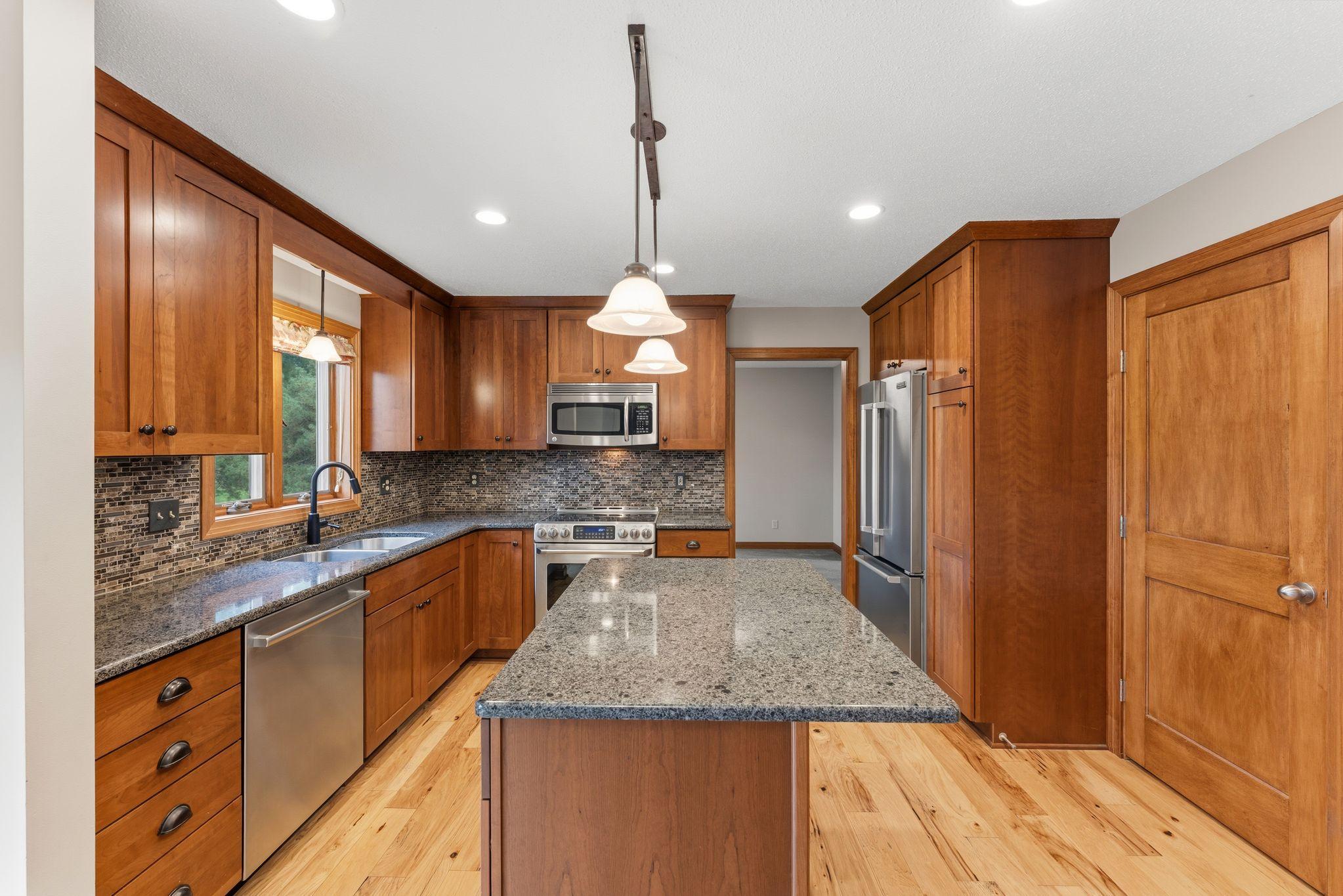 GORGEOUS kitchen -- giving you the WOW-factor!!! Cherry cabinets with soft-close doors, high-end SS appliances, Cambria/quartz countertops, updated lighting, Hickory HW flooring!!!