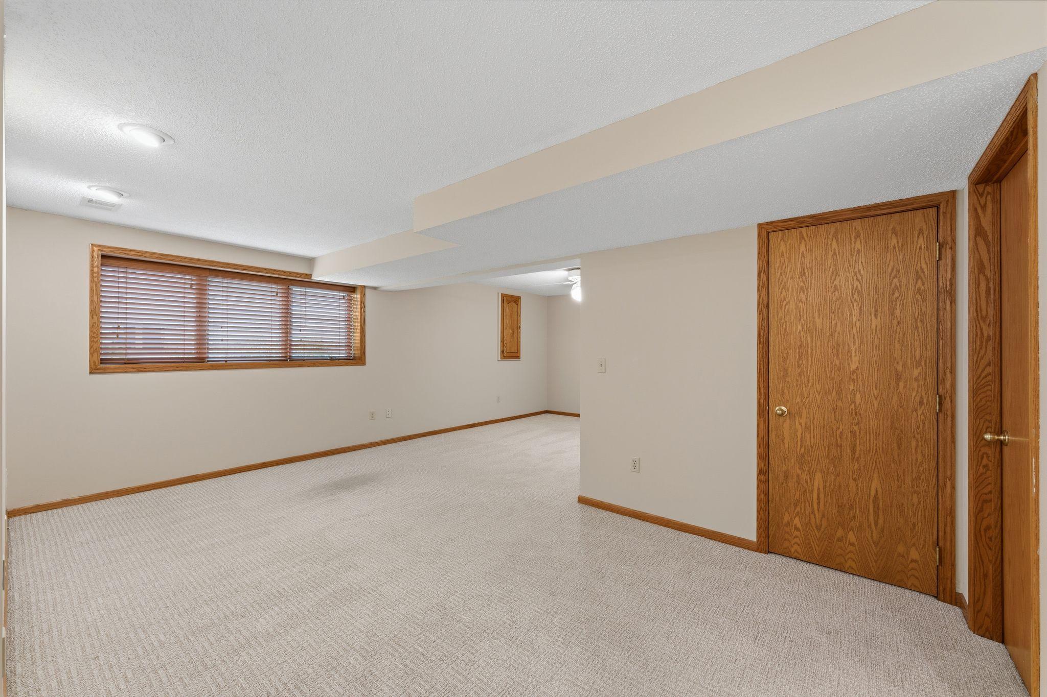 Lower level family room -- tons of space to entertain and have game-night! There is also a HUGE storage room -- perfect for seasonal items!!