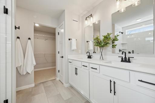 Primary bath with double sinks and walk-in closet