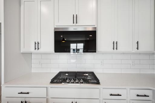 Gas cooktop and microwave with air fryer that vents to exterior.