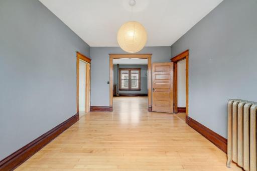 Large dining area to living area beautiful maple floors and woodwork.jpg