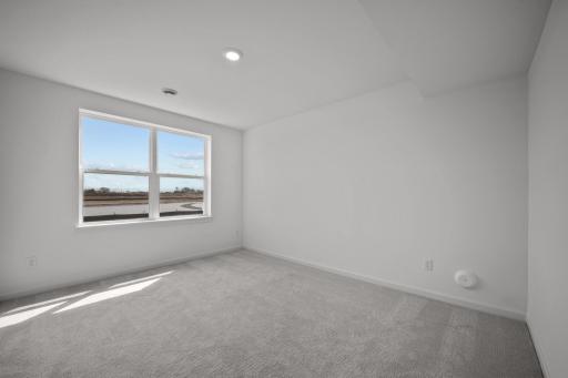 Comfortable secondary bedroom in the McBee plan ideal for guests or family use. Images are from a similar home, interior selections may differ
