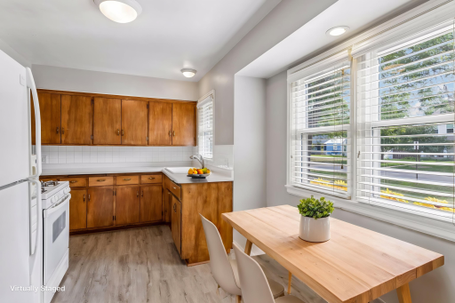 Virtually staged with bistro seating in breakfast nook features new luxury vinyl plank flooring and fresh paint.