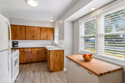 Virtually staged with additional storage and countertop space in breakfast nook features new luxury vinyl plank flooring and fresh paint.