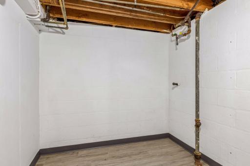 Storage room on the lower level with new luxury vinly plank flooring and fresh paint.