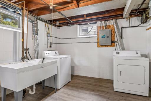 Laundry/mechanical room with additional storage features luxury vinyl plank flooring. The home features a new furnace.