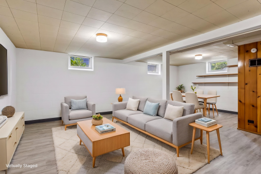 Virtually staged. The lower level offers a large versatile living space featuring luxury vinyl plank flooring and fresh paint.