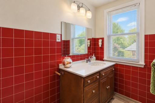 Charming half bathroom featuring classic red tile that adds character and personality.