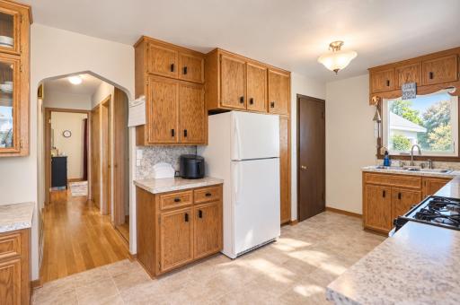 View down the hallway from the kitchen. Fresh paint in the kitchen and throughout the home. All kitchen appliances stay with the home.