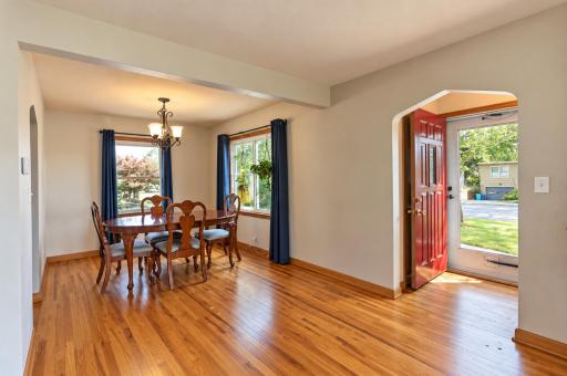 Formal dining room features hardwood floors, large windows, and a perfect space to entertain family and friends.