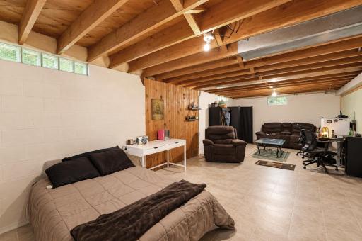 Spacious and open unfinished lower level - Easy to utilize this space for any possible needs with the laminate flooring and painted walls.