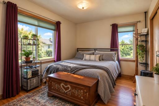 Bright and comfortable main floor bedroom with hardwood floors and ample closet space.
