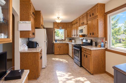 Spacious kitchen offers an abundance of cabinetry and countertop space. Large kitchen windows fill the room with natural light.
