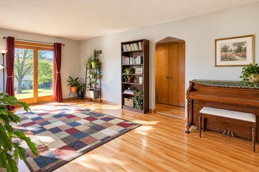 View from the freshly painted living room into the hallway leading to the main floor full bathroom, main floor laundry, and main floor bedroom.