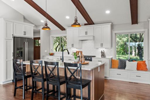 Custom cabinets and an island with extra storage along with places to eat.