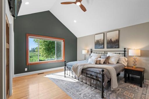 The main floor primary bedroom has two closets and features vaulted ceilings.