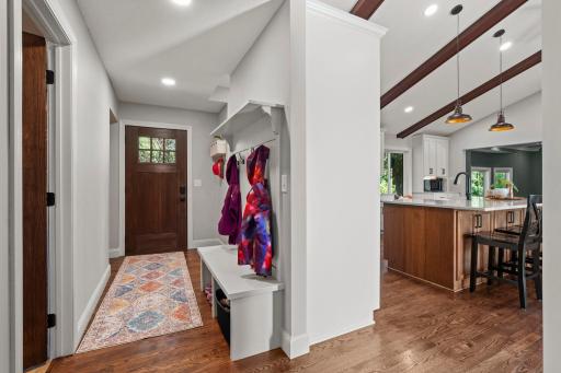 Mudroom with kitchen on the right and bathroom door on the left.