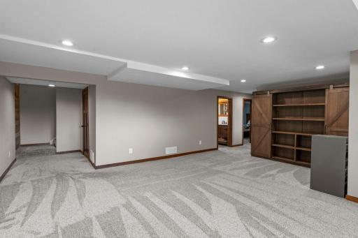 The laundry room is on the side of this photo of the lower level family room.