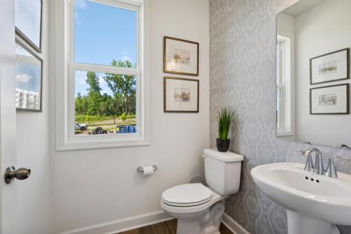 (Photo of decorated model, actual home's finishes will vary) Conveniently placed near the Great Room, the powder room is conveniently trucked away with privacy in mind.
