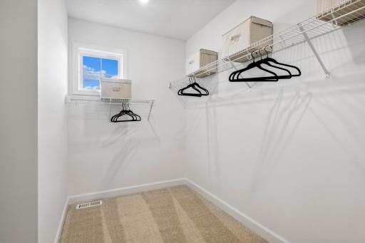 (Photo of decorated model, actual home's finishes will vary) The primary bedroom features an incredible walk-in closet.