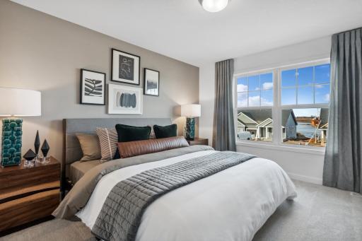 (Photo of decorated model, actual home's finishes will vary) Secondary bedroom with a spacious closet.