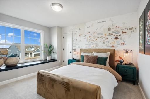 (Photo of decorated model, actual home's finishes will vary) Secondary bedroom with a spacious closet.