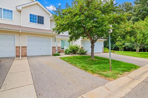Walkup to a welcoming view of a well maintained lawn and trees.