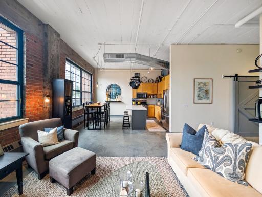 Open-concept, vaulted, and bright from large windows with a beautiful city view!